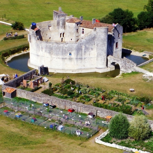 Vue aérienne du château fort de la Fée Mélusine à Saint-Jean-d’Angle entouré de ses douves et animations médiévales