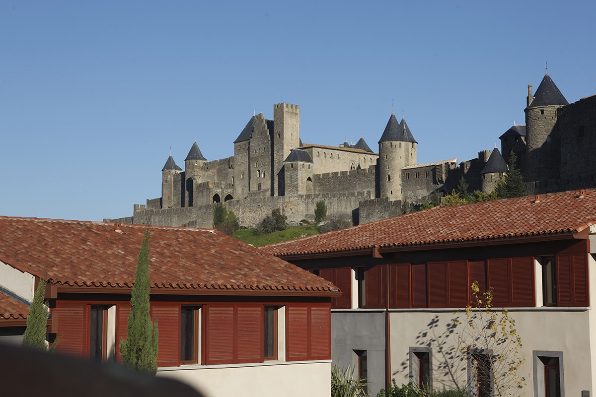 Hébergement Adonis La Barbacane offrant une vue sur les remparts et les tours de la cité de Carcassonne.